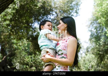 Cute portrait of mother holding her baby in autumn in the park. Concept for mother's day. Stock Photo