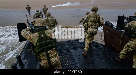 Royal Marine Commandos training in traditional amphibious drills from a landing craft operated from a Royal Navy Albion class assault ship Stock Photo