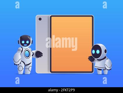 modern robots couple standing near tablet pc with blank screen robotic character artificial intelligence technology Stock Vector