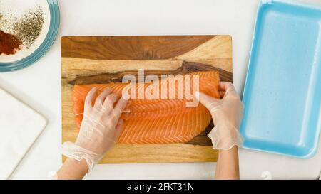 Fresh raw salmon close up on  wooden cutting board, close up view from above Stock Photo