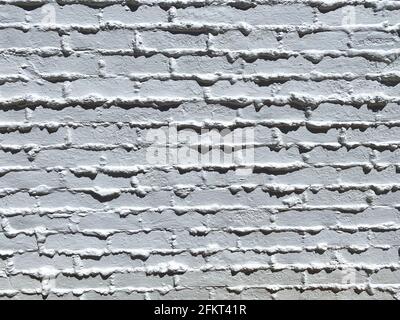 closeup view of vintage retro brick and mortar wall freshly painted white Stock Photo