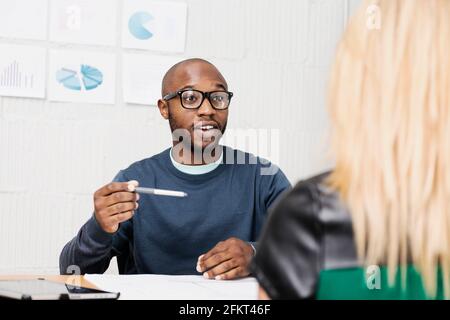 Young business partners brainstorming in design office Stock Photo