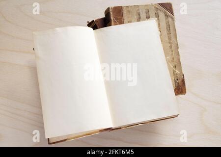 Old vintage book on wooden table. Open book with blank pages Stock Photo