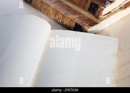 Old vintage book on wooden table. Open book with blank pages Stock Photo