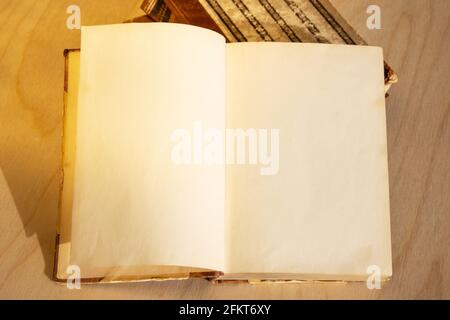 Old vintage book on wooden table. Open book with blank pages Stock Photo