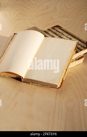 Old vintage book on wooden table. Open book with blank pages Stock Photo