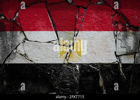 National flag of Egypt  depicting in paint colors on an old stone wall. Flag  banner on broken  wall background. Stock Photo