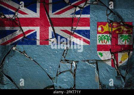 National flag of Fiji  depicting in paint colors on an old stone wall. Flag  banner on broken  wall background. Stock Photo