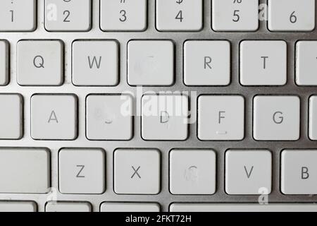 An old computer keyboard with some of the letters worn away by constant typing. Stock Photo