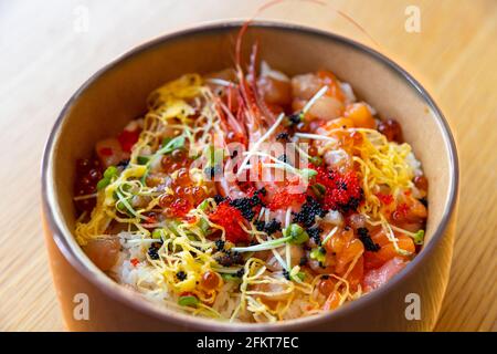 Bowl of Japanese sushi rice topped with sashimi and fish roe known as Kaisendon Donburi Stock Photo