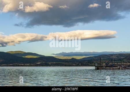 PENTICTON, CANADA - JULY 04, 2020: lake landscape with sailboats calm morning with cloudy sky Stock Photo