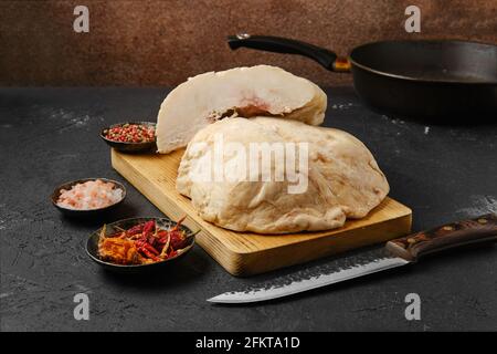 https://l450v.alamy.com/450v/2fkta1d/cut-lamb-fat-tail-on-kitchen-table-with-salt-and-pepper-2fkta1d.jpg