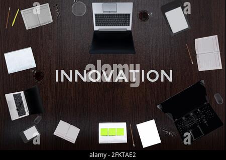 Innovation concept. Top layout of drawings of laptops, notepads, coffee, different business stuff on black background. Stock Photo