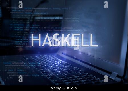 Haskell inscription against laptop and code background. Technology concept. Learn programming language. Stock Photo
