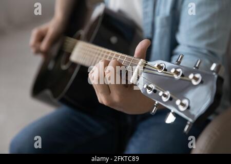 Close up man playing acoustic guitar, artist musician making music Stock Photo