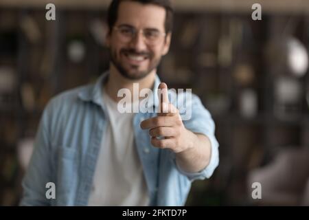 Close up smiling man pointing finger at camera, choosing you Stock Photo