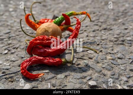 lemon chilli bundle on the street. An old practice of throwing lemon and chilli bundle as a part of taboo in INDIA to avoid bad luck. Stock Photo