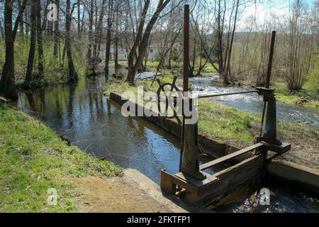 The old defunct floodgate on the small river near Husinec in Czech Republic. Inoperative for a long time. Stock Photo