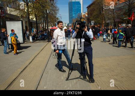 CHELYABINSK, RUSSIA, MAY 09, 2017: journalist with microphone interviewing woman on street. Annual Victory Day on May 9. Stock Photo
