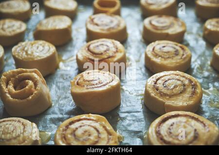 Blanks for baking cinnamon rolls on baking sheet with parchment paper Stock Photo
