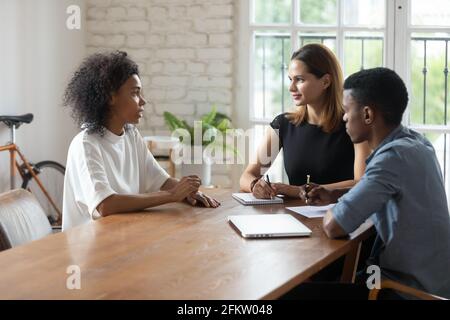 Young african female job seeker holding interview with hr managers. Stock Photo
