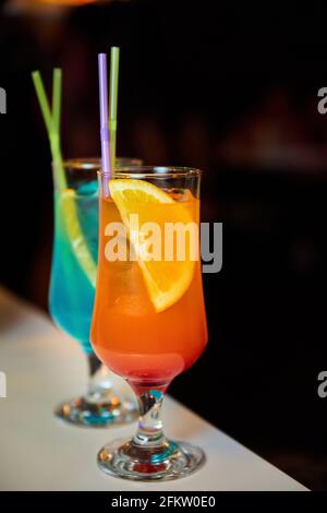 Multicolored alcoholic and non-alcoholic cocktails with ice and straws Stock Photo