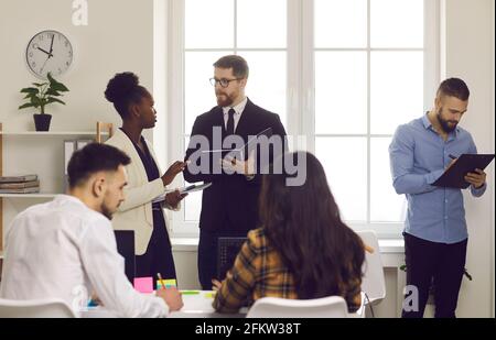 Group of international business people work and communicate in a coworking center. Stock Photo