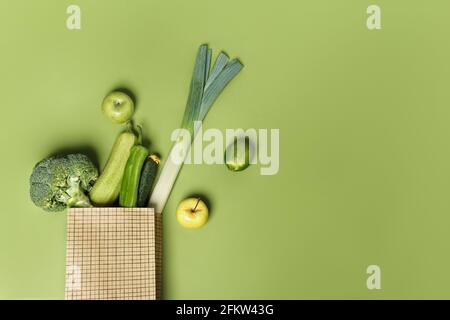Creative layout made of cucumber, green pepper, broccoli, leek, apple, avocado, lime, zucchini. Flat lay. Food concept. Stock Photo
