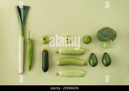 Creative layout made of cucumber, green pepper, broccoli, leek, apple, avocado, lime, zucchini. Flat lay. Food concept. Stock Photo