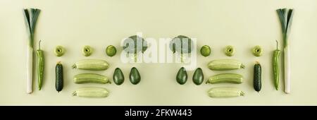 Creative layout made of cucumber, green pepper, broccoli, leek, apple, avocado, lime, zucchini. Flat lay. Food concept. Web banner. Stock Photo