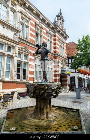 Hamelin, Germany - August 20, 2019: Fountain with a statue of the Pied Piper on a street in Hamelin, Lower Saxony, Germany Stock Photo