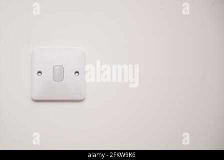 Light switch on a white wall Stock Photo