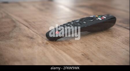 TV remote control on wooden table Stock Photo
