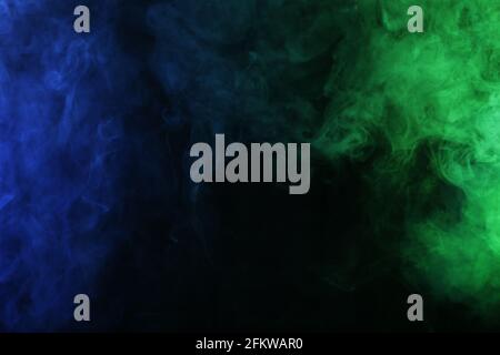 Smoke in blue green light on black background Stock Photo