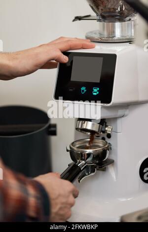 Barista using a coffee machine to make coffee Stock Photo