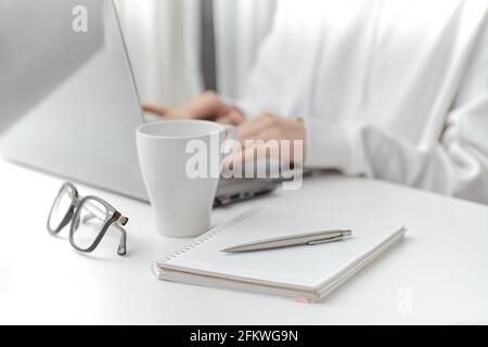 A female make a note at work. Close-up Stock Photo