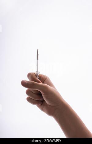 Hand holding a circuit tester screwdriver on a white background Stock Photo