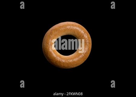 Wheat choux pastry loaf in the form of a ring. bagel isolated on black background. High quality photo Stock Photo