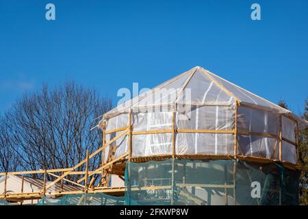 Roof renewal project on construction side on a sunny day. Housing development. Stock Photo