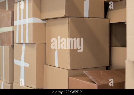 Stack of cardboard boxes ready to be shipped of a warehouse. Package storage room. Stock Photo