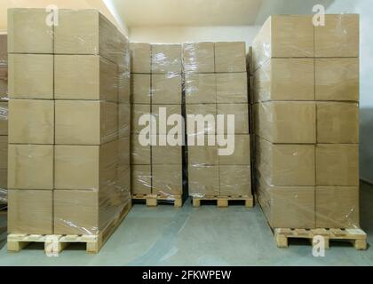 Stack of cardboard boxes ready to be shipped of a warehouse. Package storage room. Stock Photo