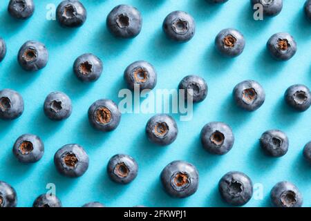 Blueberry pattern on blue background. Ripe blueberries texture close up. Stock Photo