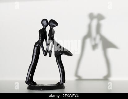 couple figures kissing with shadow Stock Photo