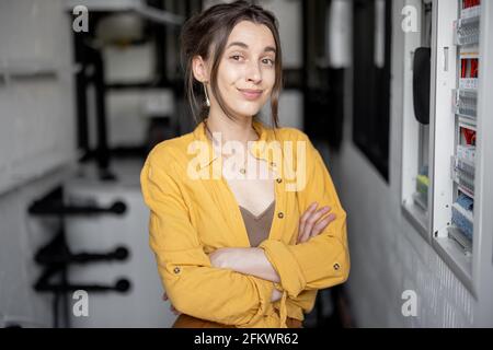 A portrait of young housewife standing in the boiler room at home. Stock Photo