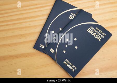 Two Brazilian passports on top of wooden table, Top View. Stock Photo