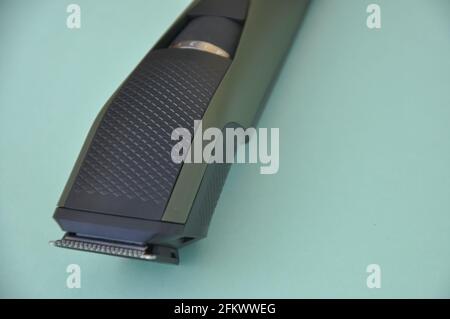 Close up shot of beard trimmer without comb isolated on green background. Stock Photo