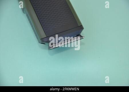 Close up shot of beard trimmer without comb isolated on green background. Stock Photo