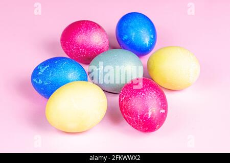 Colorful painted Easter eggs decorations on light pink background. Stock Photo