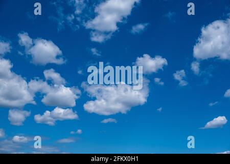 Cloudscape on blue sky background. Fluffy cumulus clouds white and grey color, Abstract texture. Stock Photo