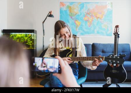 Mom records her daughter on the phone. Video blog concept. Stock Photo